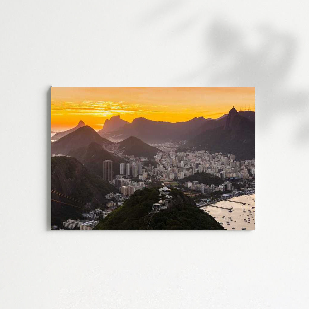 Rio's Sunset Charm: City and Mountains Under Orange Sky
