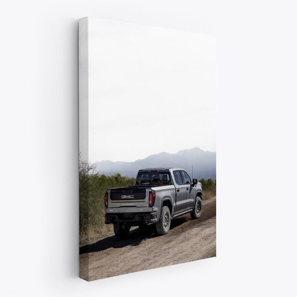 GMC Sierra Kicking Up Dust on Dirt Road - Power and Grit
