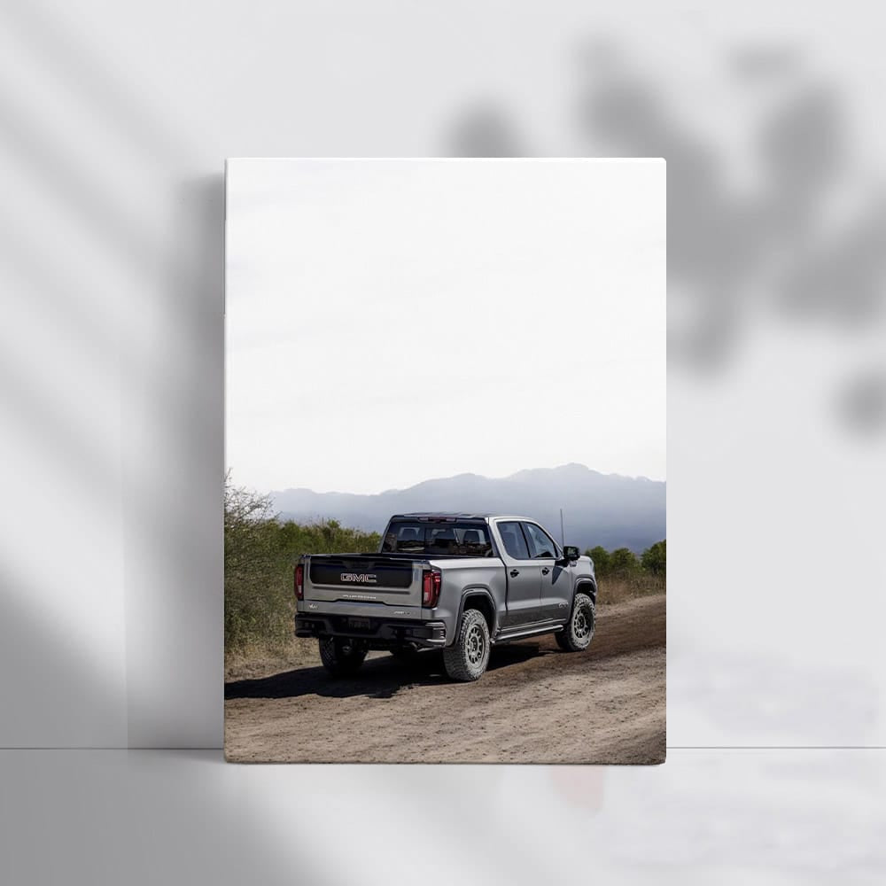 GMC Sierra Kicking Up Dust on Dirt Road - Power and Grit