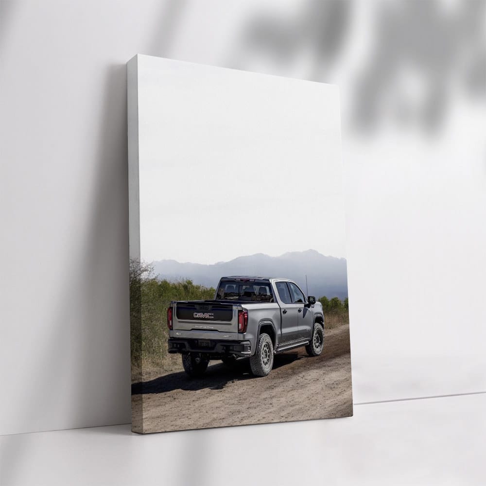 GMC Sierra Kicking Up Dust on Dirt Road - Power and Grit