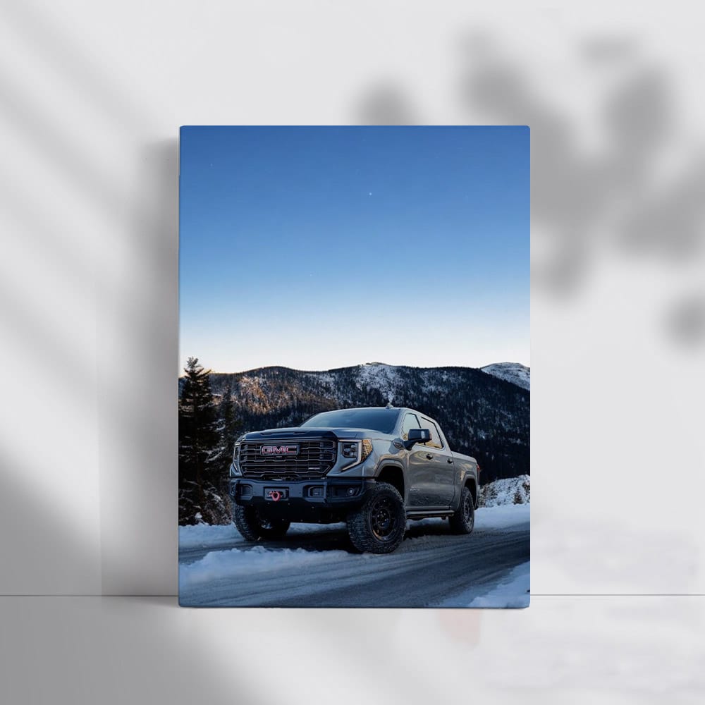 GMC Sierra Navigating Snowy Mountain Road under Starry Sky - Rugged and Reliable