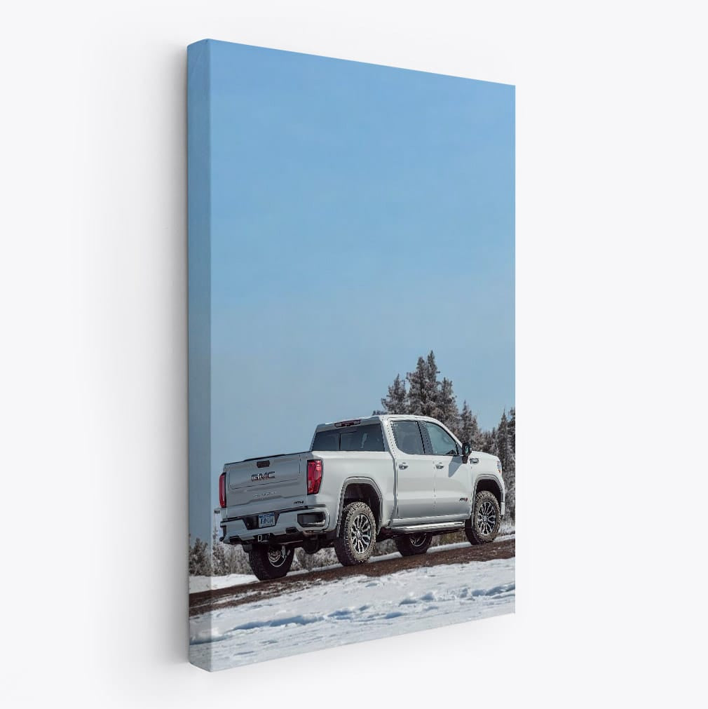 GMC Sierra Navigates Snowy Path Under Clear Blue Sky - Rugged Elegance
