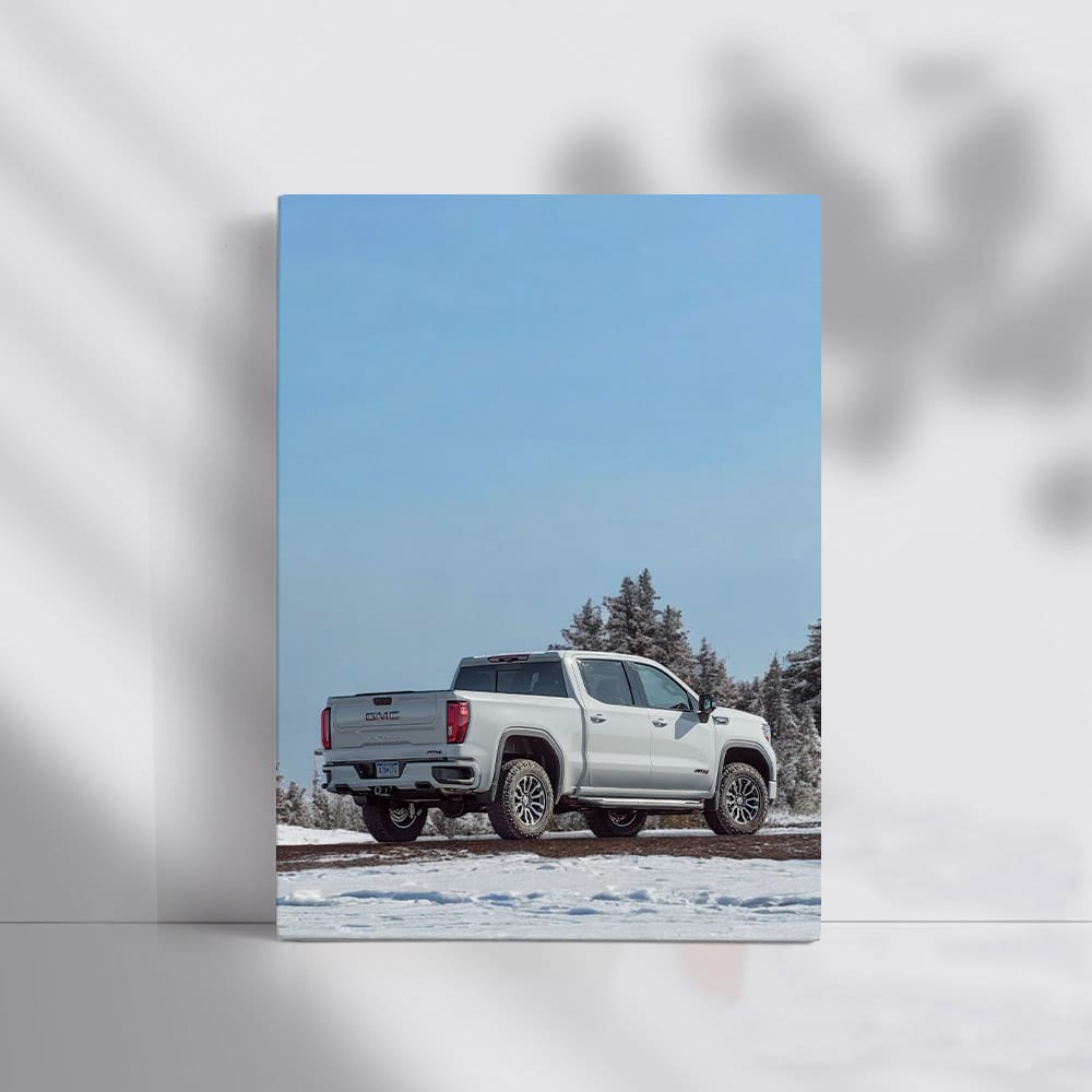 GMC Sierra Navigates Snowy Path Under Clear Blue Sky - Rugged Elegance