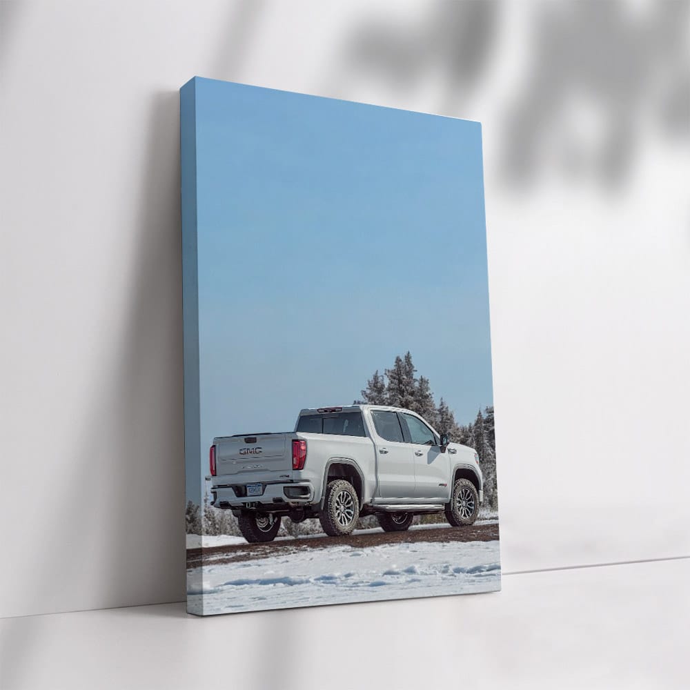 GMC Sierra Navigates Snowy Path Under Clear Blue Sky - Rugged Elegance