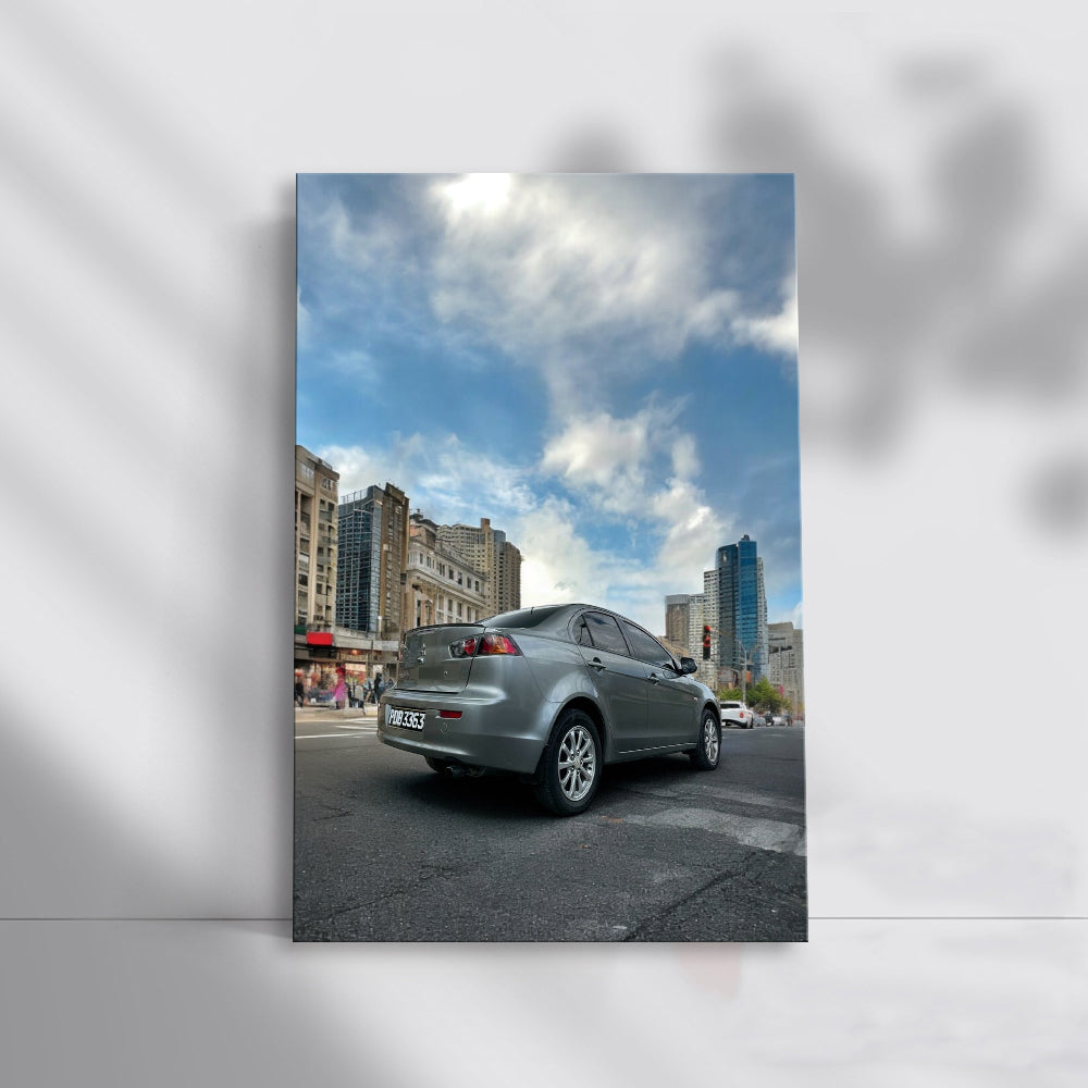 Gray Mitsubishi Lancer Cruising Through Urban Streets - Sleek
