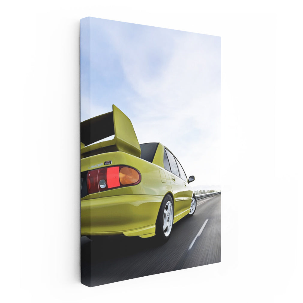 Yellow Mitsubishi Lancer Driving Down Road - Sporty & Bold