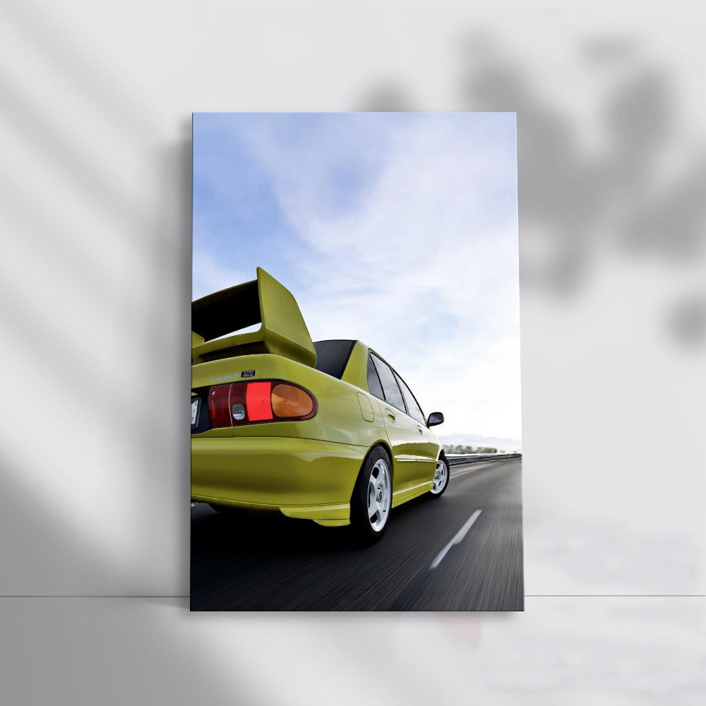 Yellow Mitsubishi Lancer Driving Down Road - Sporty & Bold