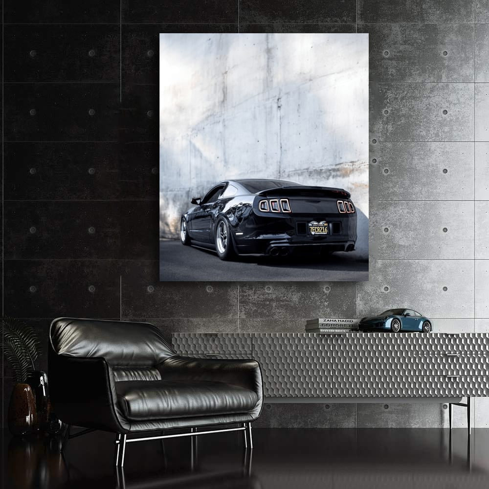 Black Mustang Against Concrete Wall - Power and Elegance