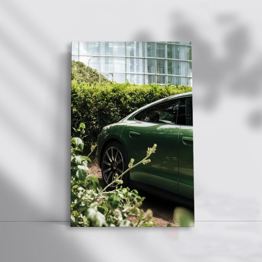 Sleek Green Porsche Parked by Glass Building - Style Meets Speed