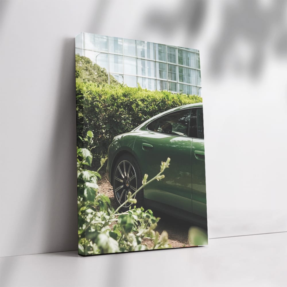 Sleek Green Porsche Parked by Glass Building - Style Meets Speed