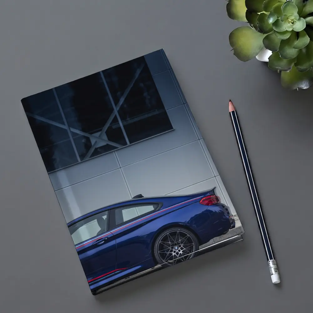 BMW M4 Blue Coupe Against Modern Building – Notebooks