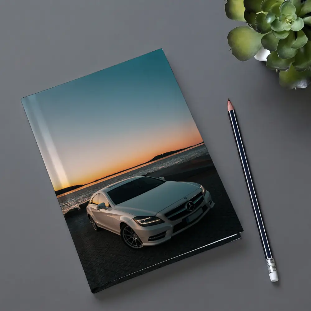 White Mercedes CLS Parked by Sunset Shore – Notebooks