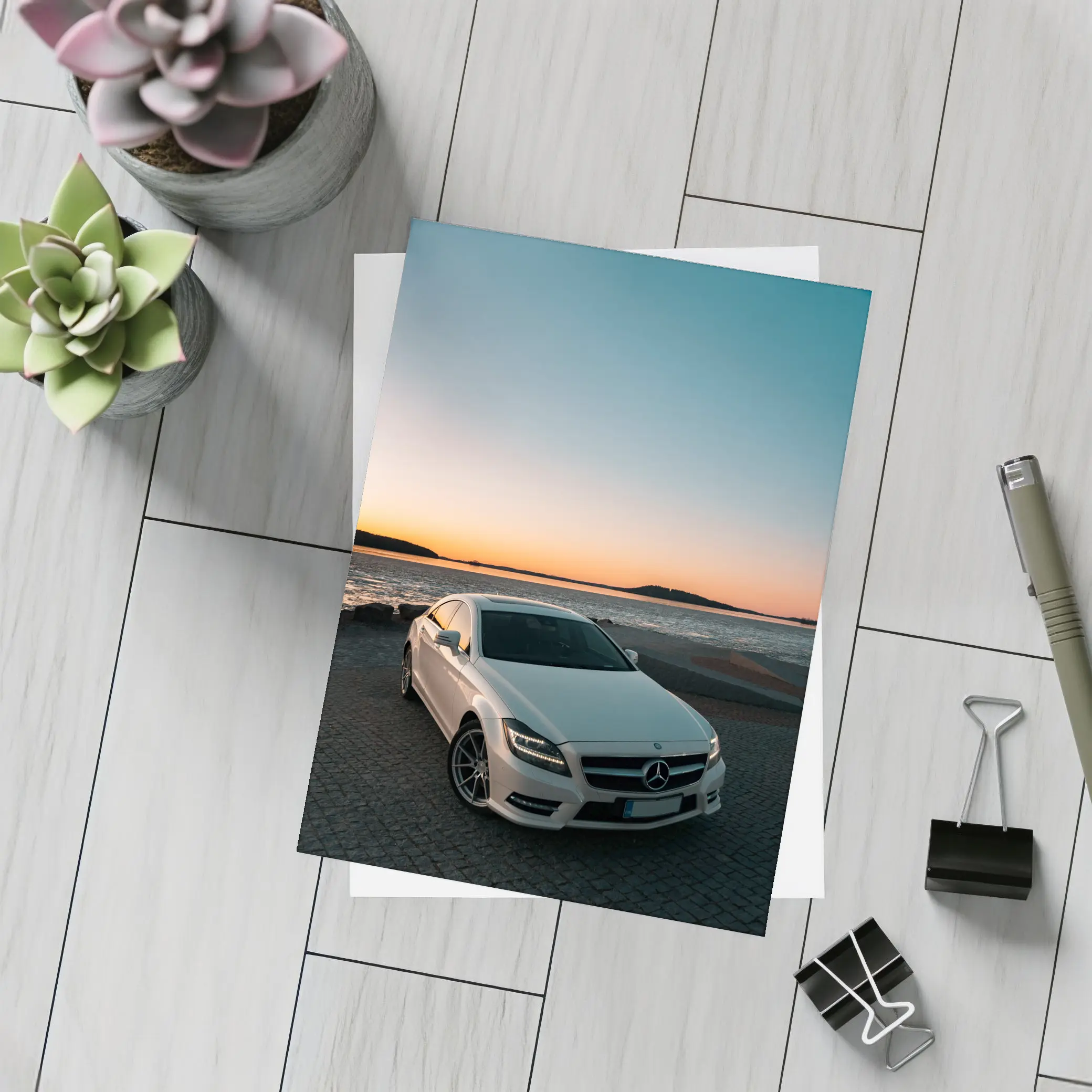 White Mercedes CLS Parked by Sunset Shore – Postcards