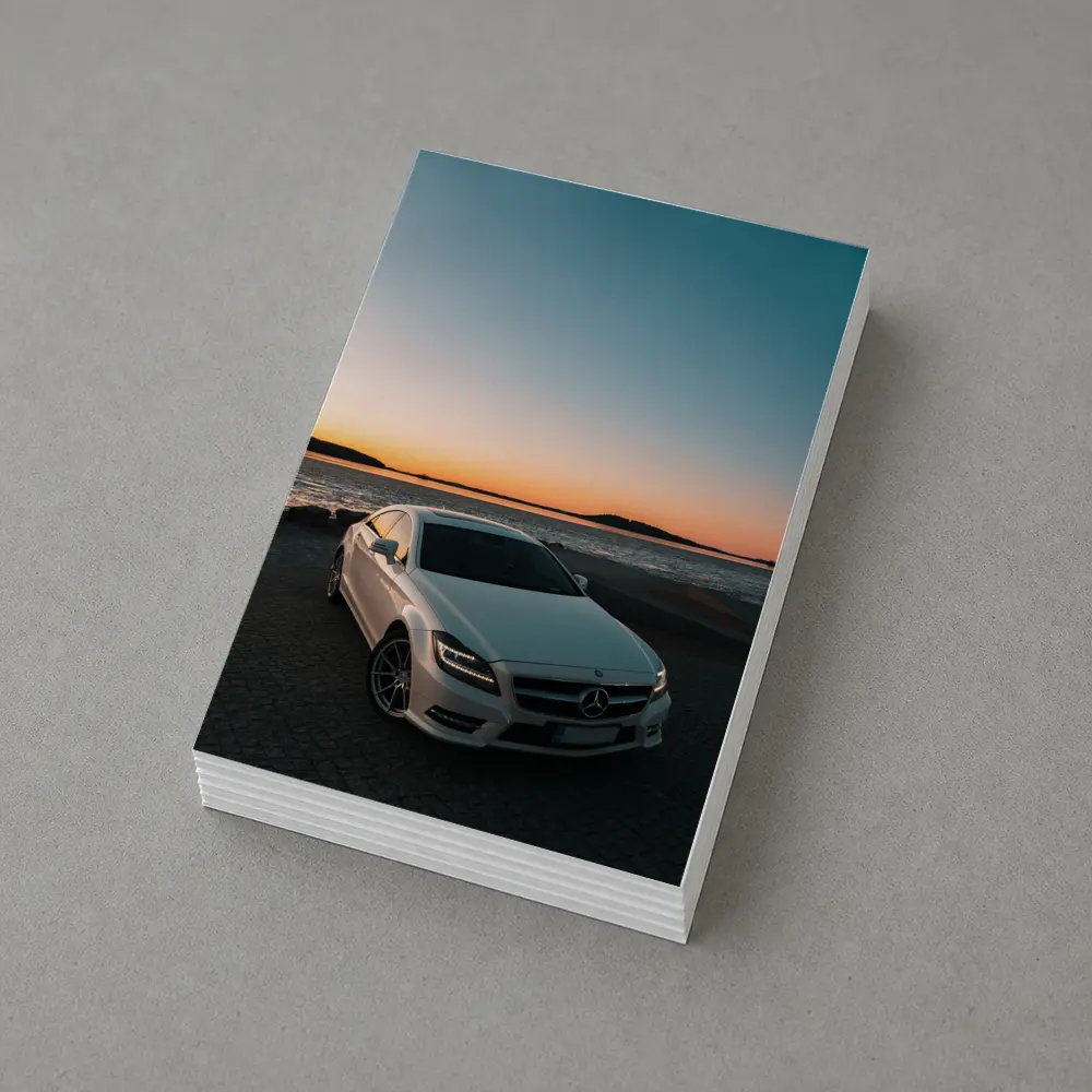 White Mercedes CLS Parked by Sunset Shore – Postcards