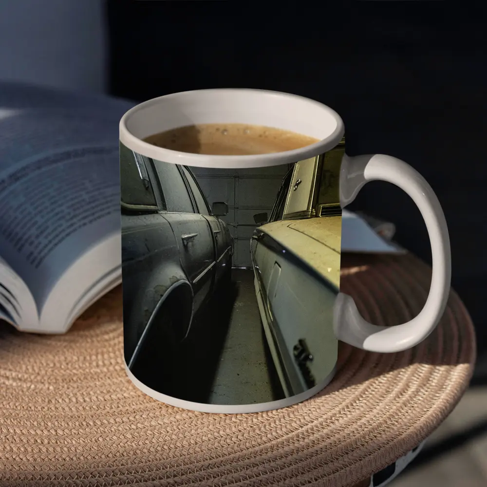 Two Classic Cars Parked Inside Dark Garage – Mugs