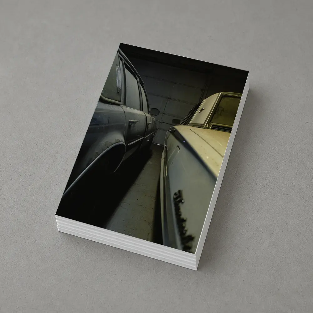 Two Classic Cars Parked Inside Dark Garage – Postcards