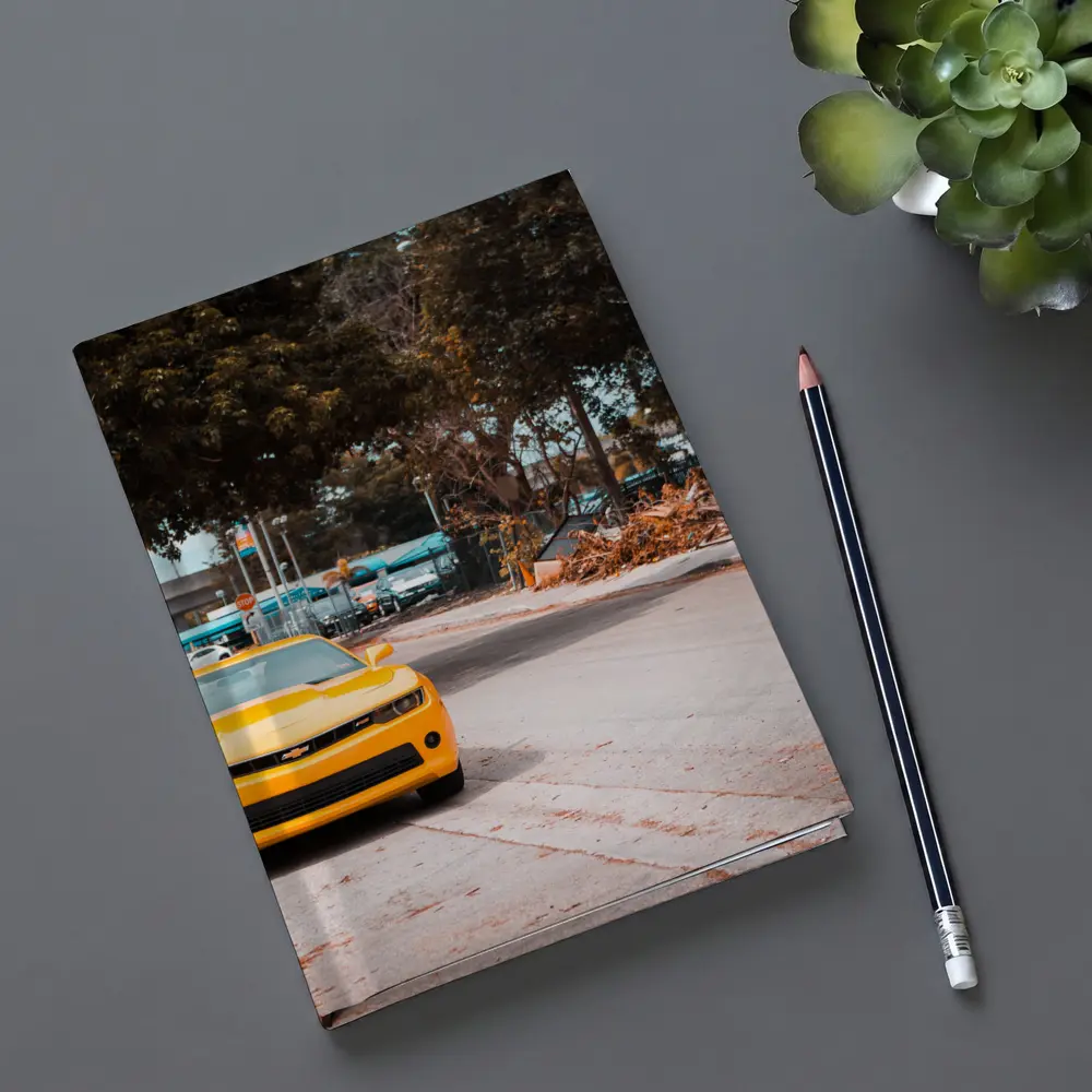 Yellow Chevrolet Camaro on Urban Street – Notebooks