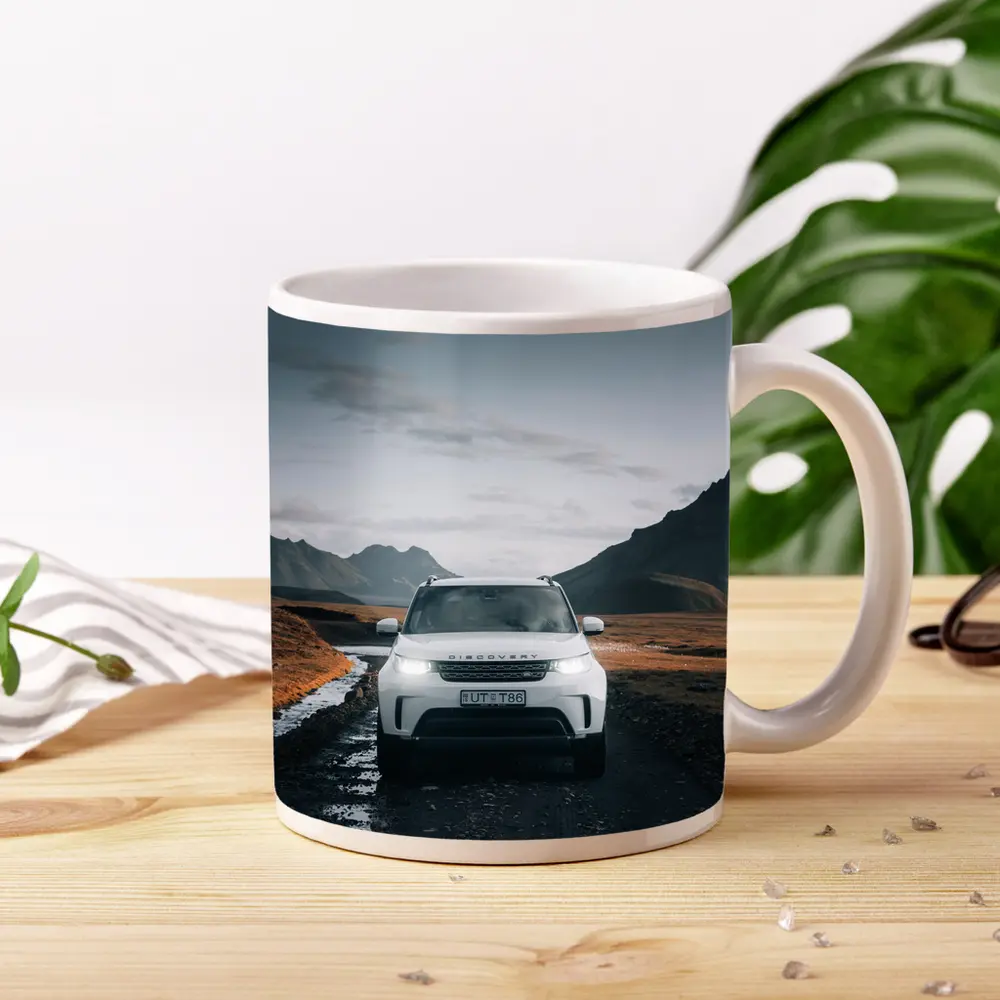 Land Rover Discovery on Rugged Mountain Road – Mugs