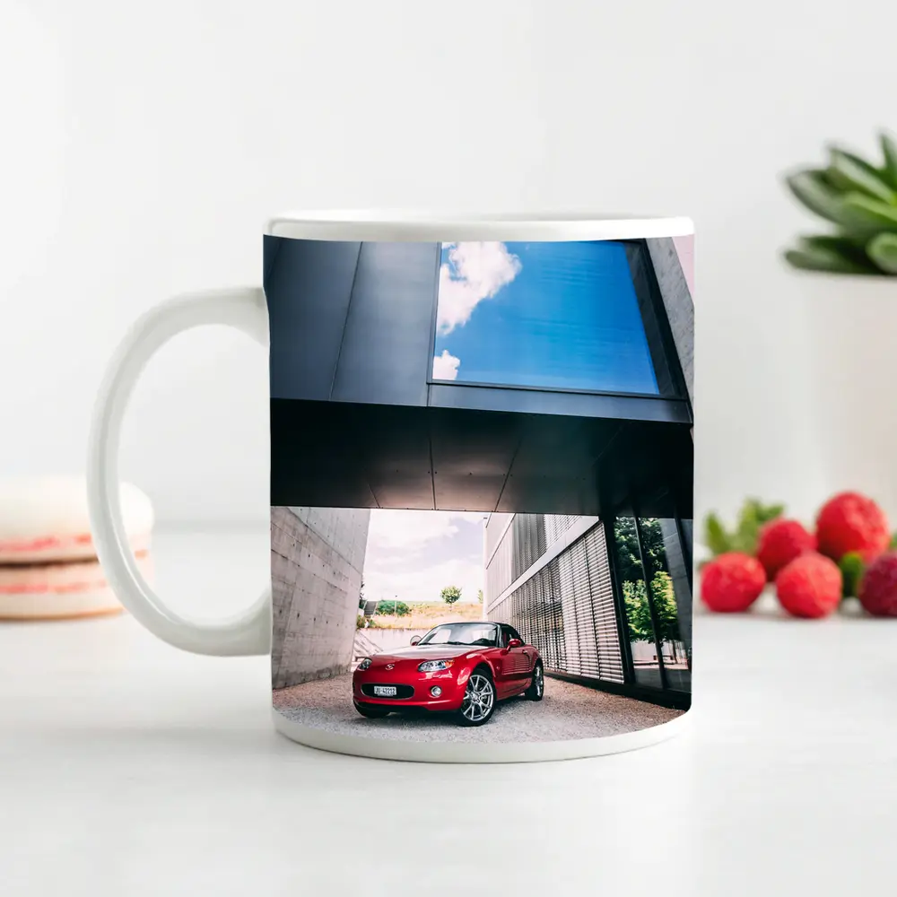 Red Mazda MX5 Parked Under Modern Architecture – Mugs