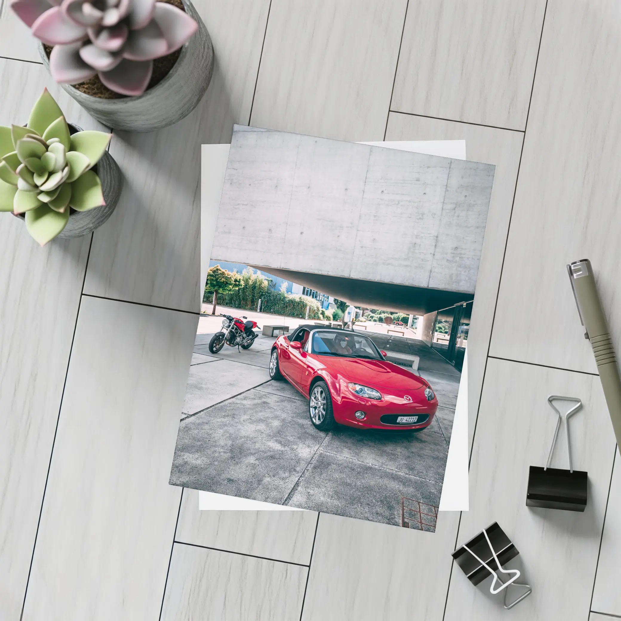 Red Mazda MX5 Parked Near Concrete Structure – Postcards