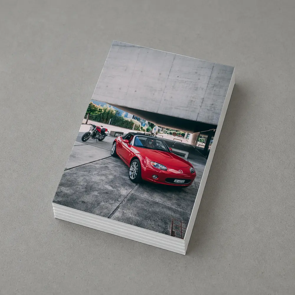 Red Mazda MX5 Parked Near Concrete Structure – Postcards