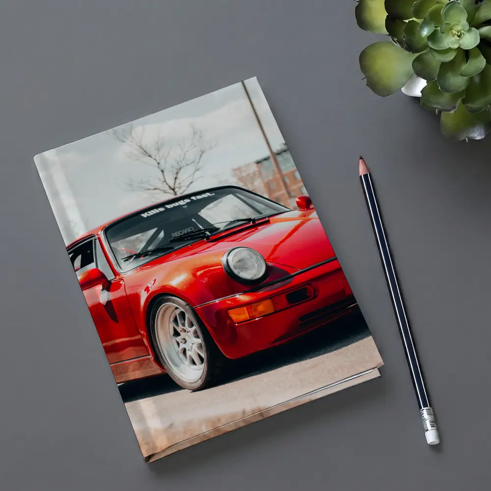 Red Porsche 911 Parked on Urban Street – Notebooks