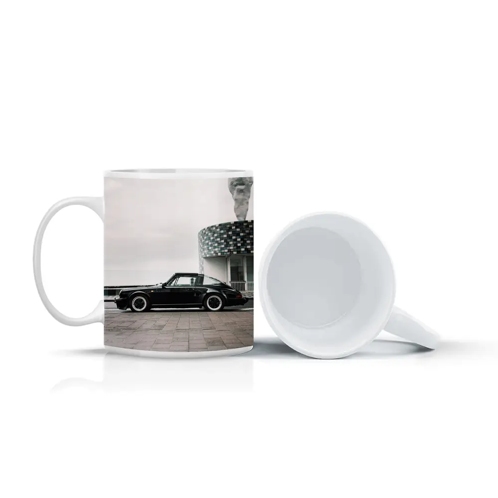 Black Porsche 911 Parked by Coastal Building – Mugs