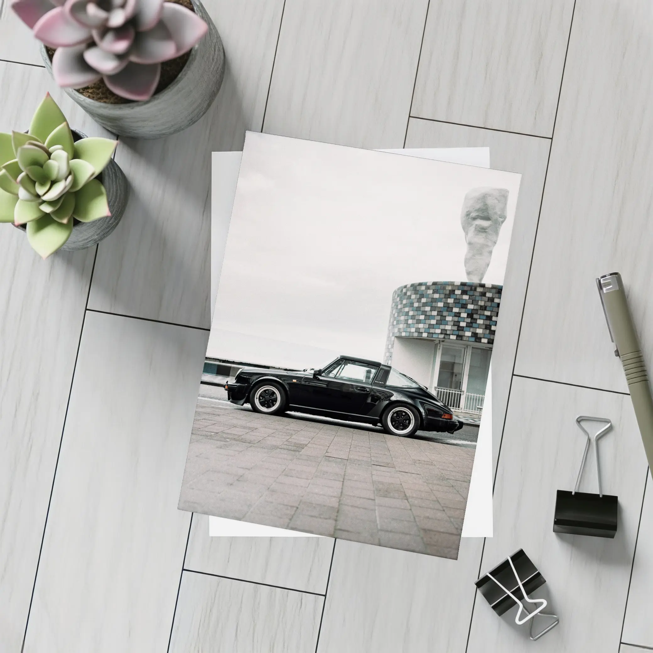 Black Porsche 911 Parked by Coastal Building – Postcards