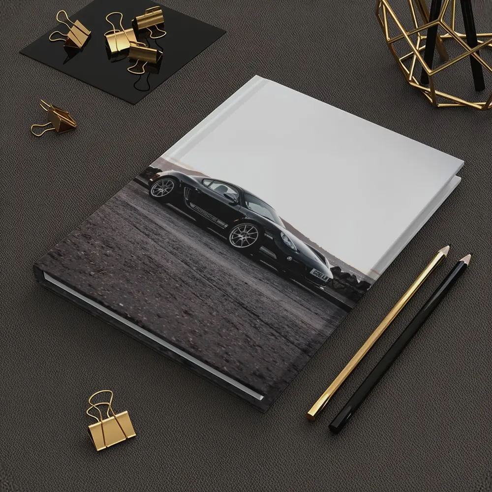 Black Porsche Cayman Parked on Rugged Terrain – Notebooks