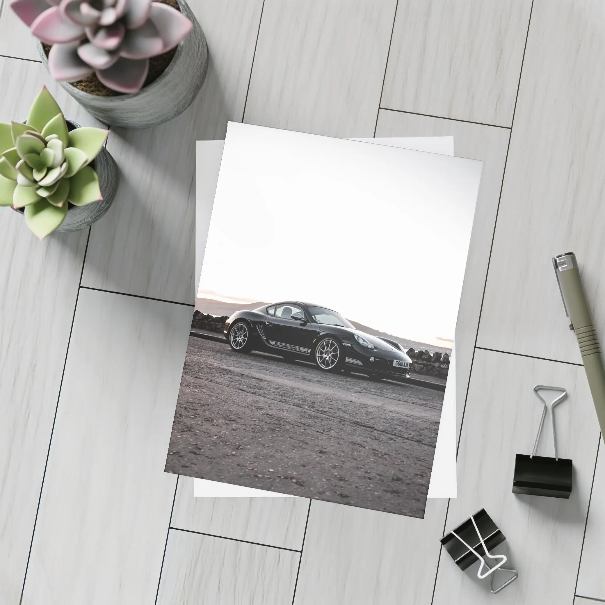 Black Porsche Cayman Parked on Rugged Terrain – Postcards