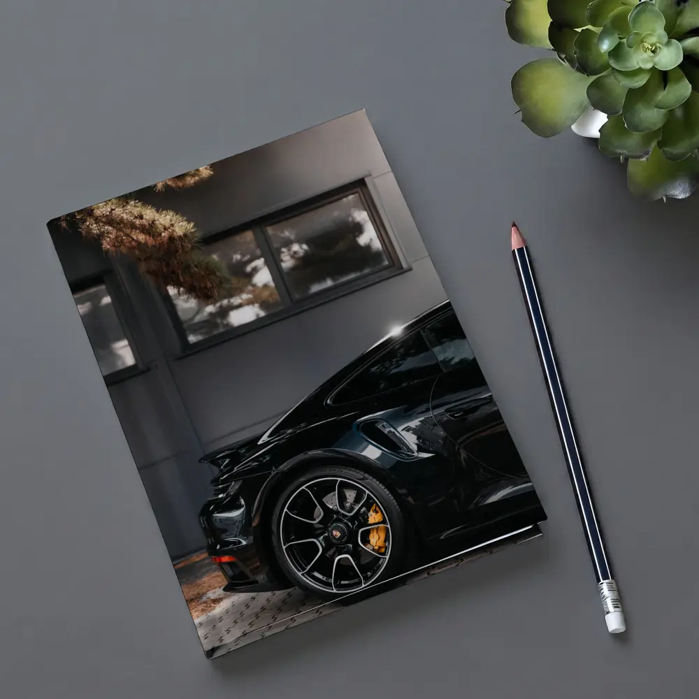 Black Porsche 911 Parked Near Building – Notebooks