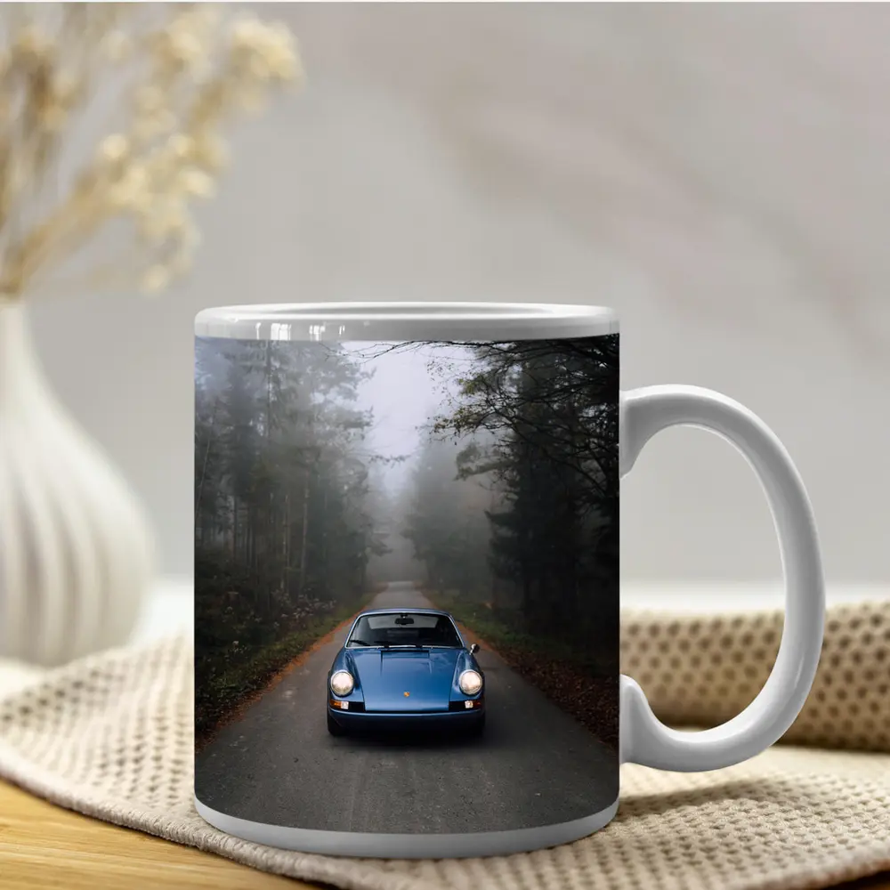 Blue Porsche 911 on Foggy Forest Road – Mugs