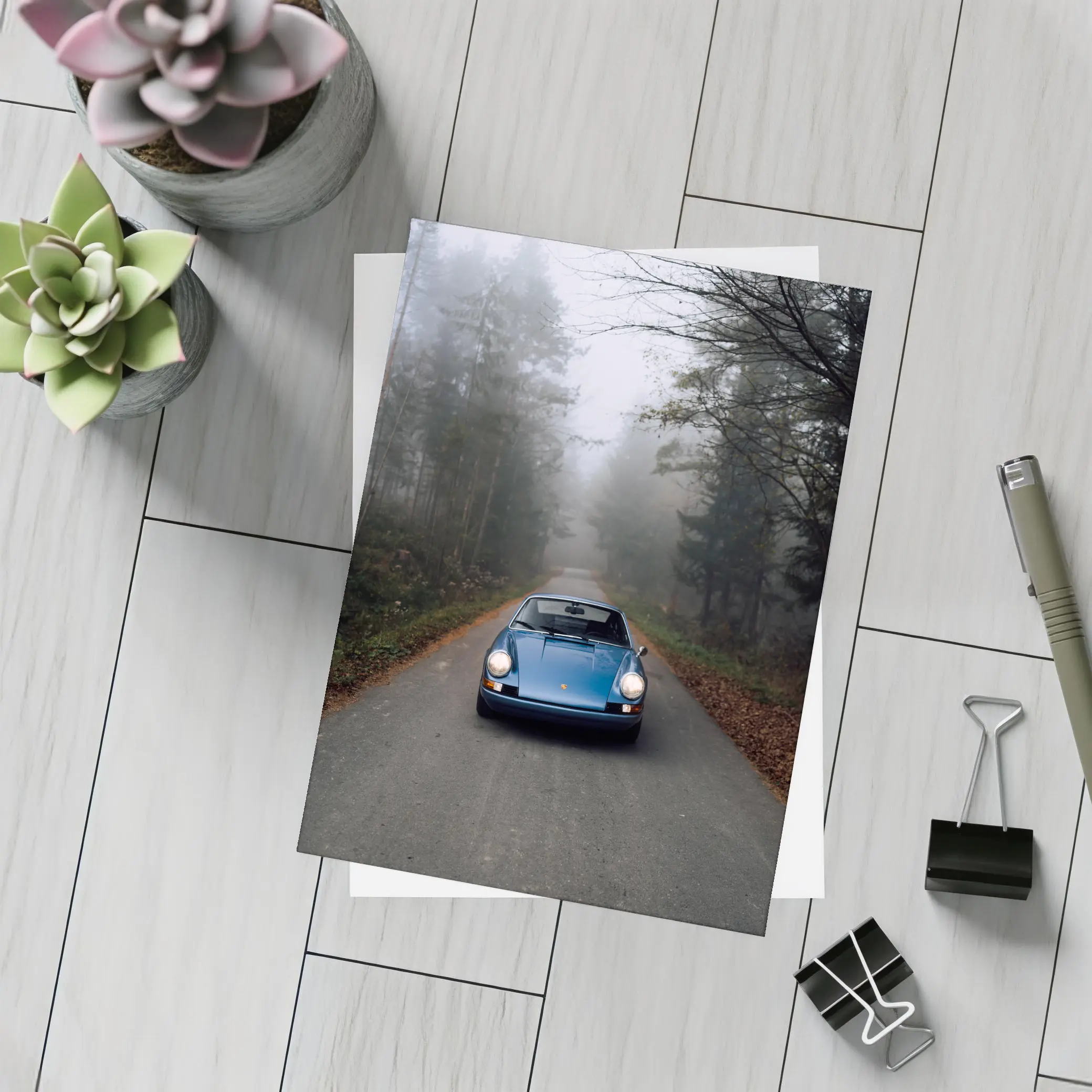 Blue Porsche 911 on Foggy Forest Road – Postcards