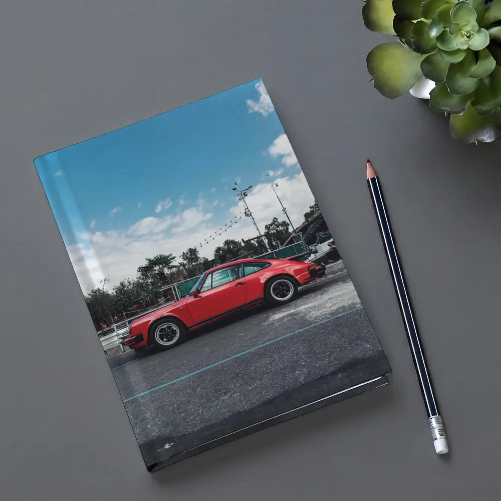 Red Porsche 911 Parked Under Blue Sky – Notebooks