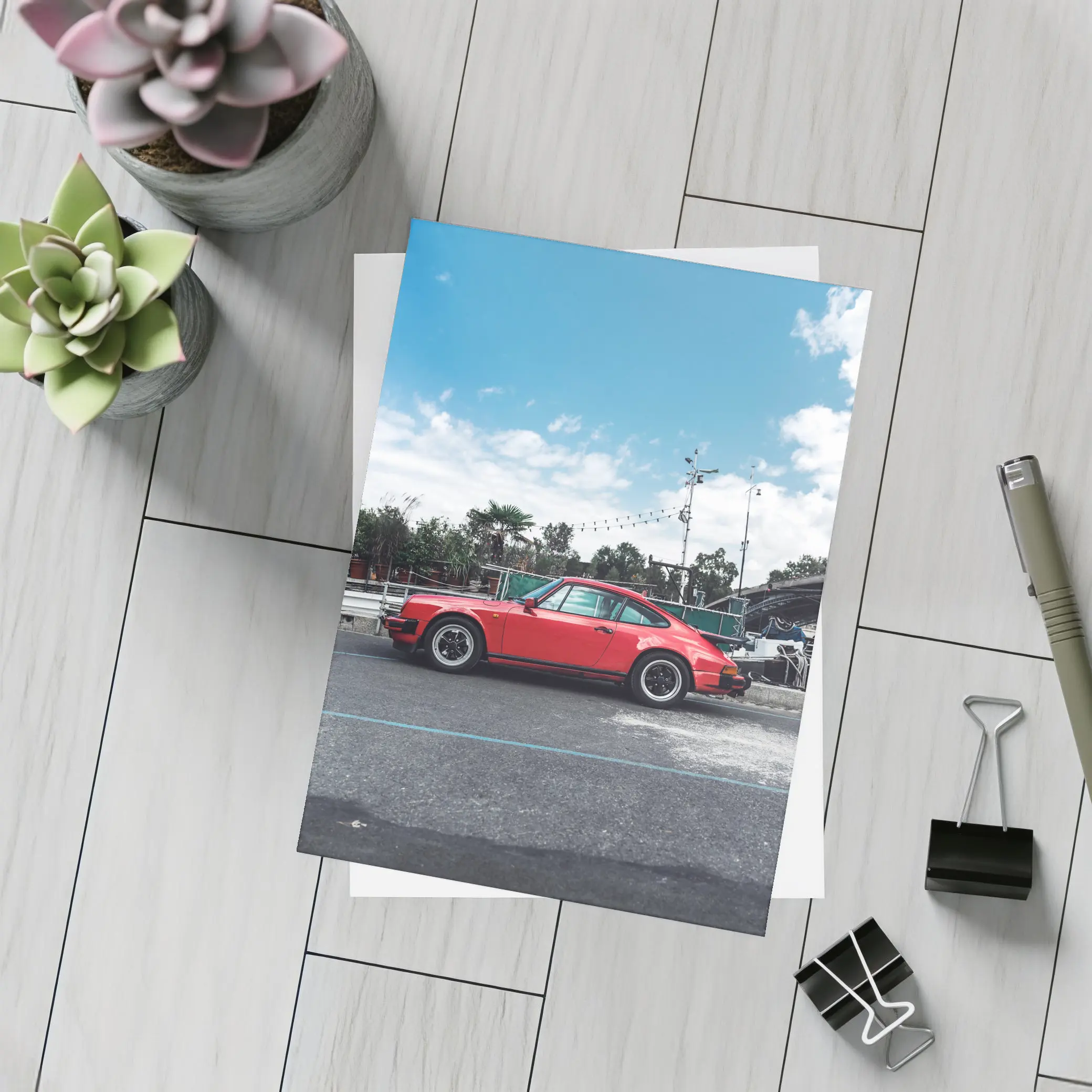 Red Porsche 911 Parked Under Blue Sky – Postcards