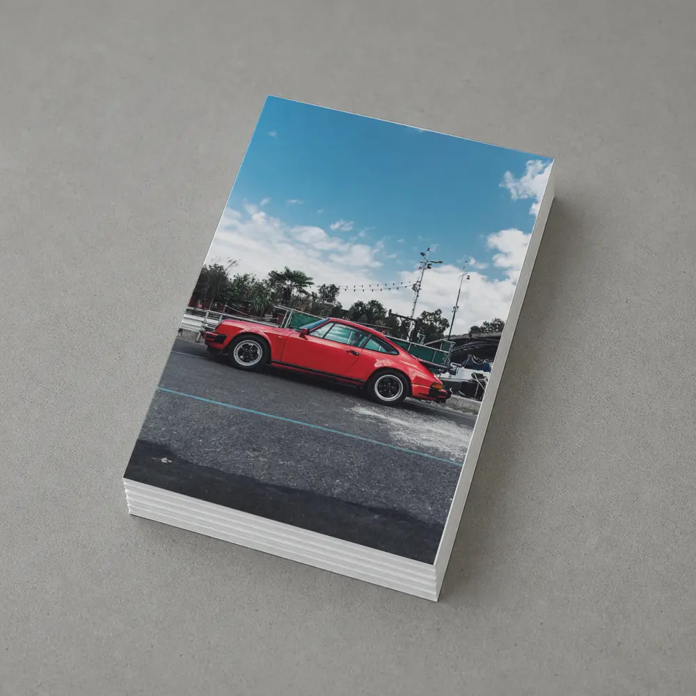 Red Porsche 911 Parked Under Blue Sky – Postcards