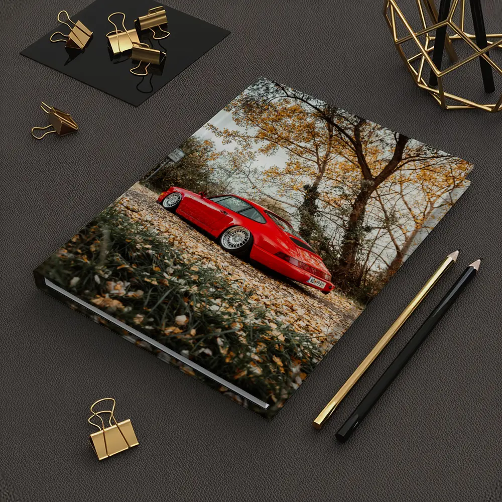 Red Porsche 911 Parked Among Autumn Leaves – Notebooks