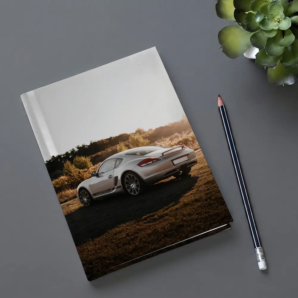 Porsche Cayman Silver Coupe Golden Hour Field – Notebooks
