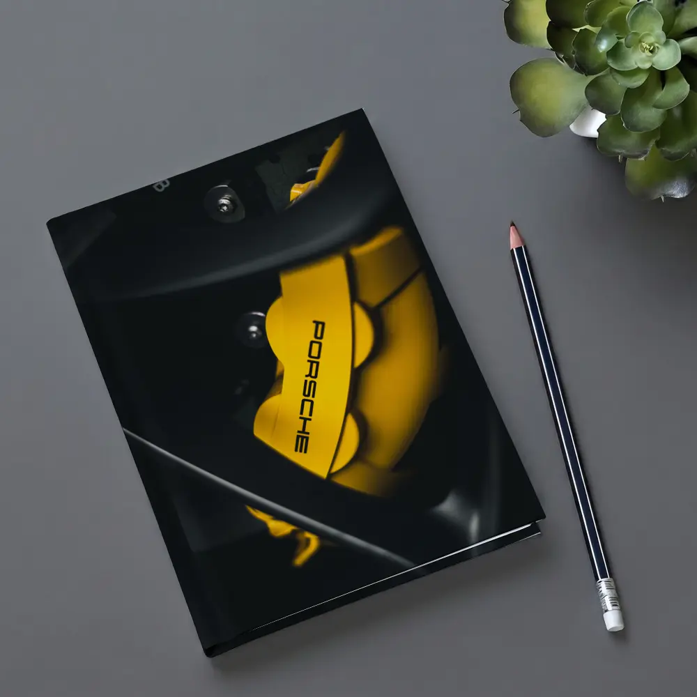 Porsche Yellow Brake Caliper Dark Background – Notebooks