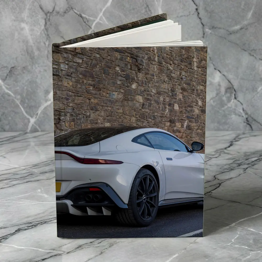 Aston Martin Vantage White Against Stone Wall – Notebooks