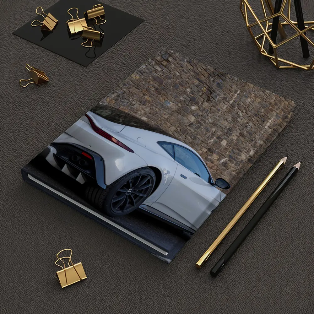 Aston Martin Vantage White Against Stone Wall – Notebooks