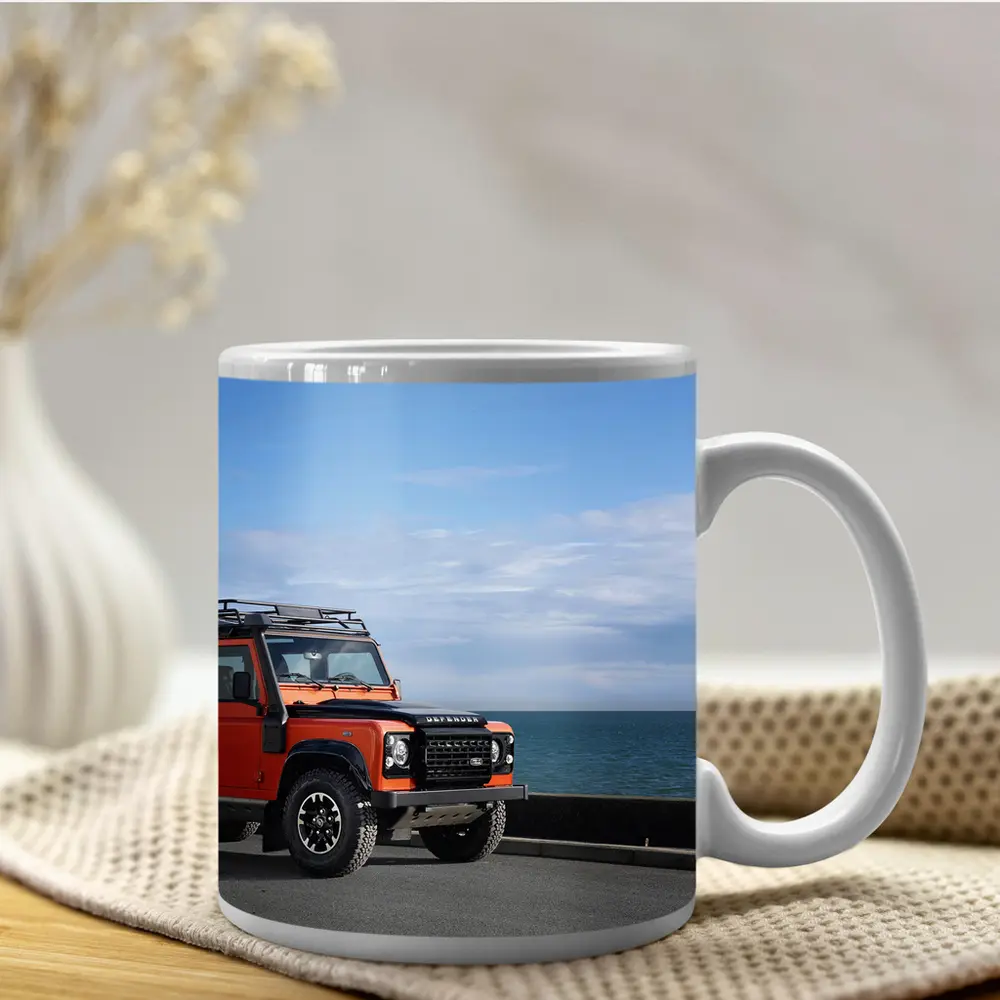 Land Rover Defender Orange Coastal Road Scene – Mugs