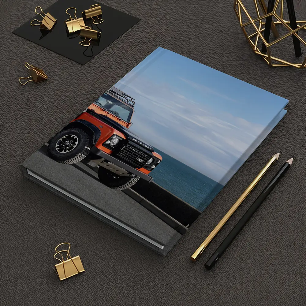 Land Rover Defender Orange Coastal Road Scene – Notebooks