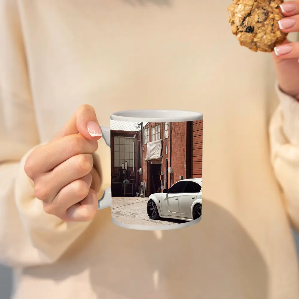 White Dodge Charger Parked Near Industrial Building – Mugs