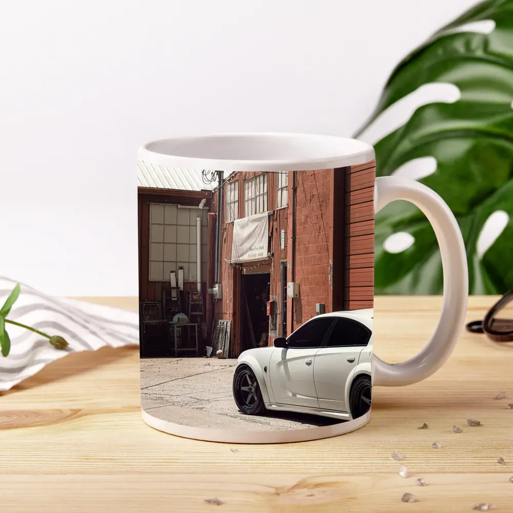 White Dodge Charger Parked Near Industrial Building – Mugs