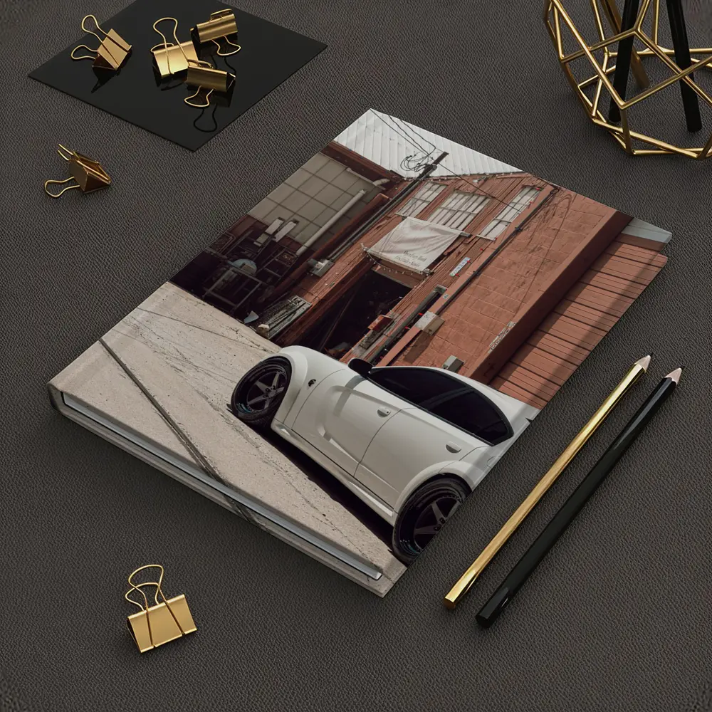 White Dodge Charger Parked Near Industrial Building – Notebooks