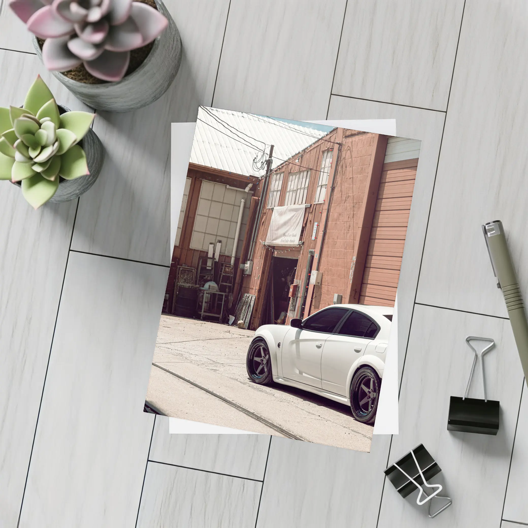 White Dodge Charger Parked Near Industrial Building – Postcards