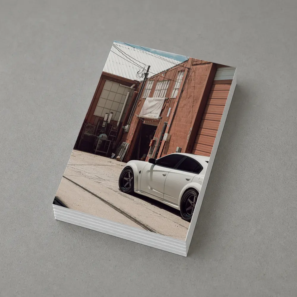 White Dodge Charger Parked Near Industrial Building – Postcards