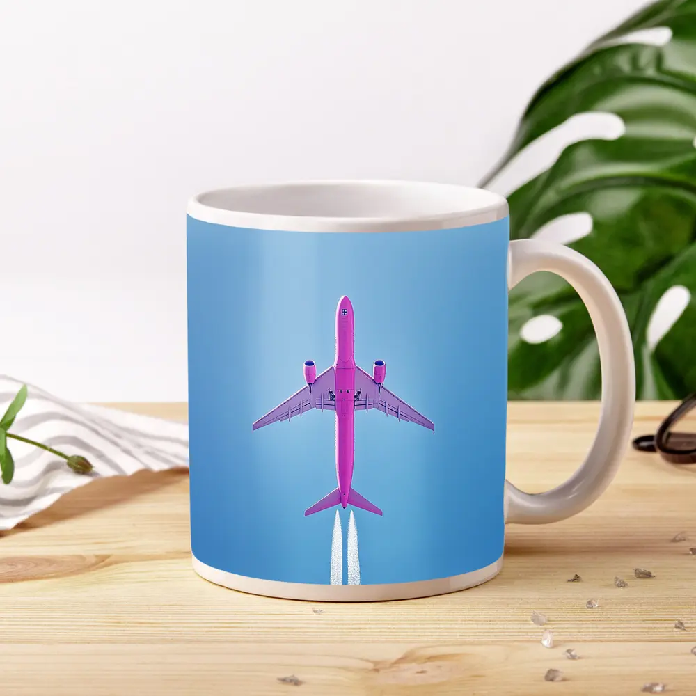 Pink Airplane Flying Against Blue Sky – Mugs