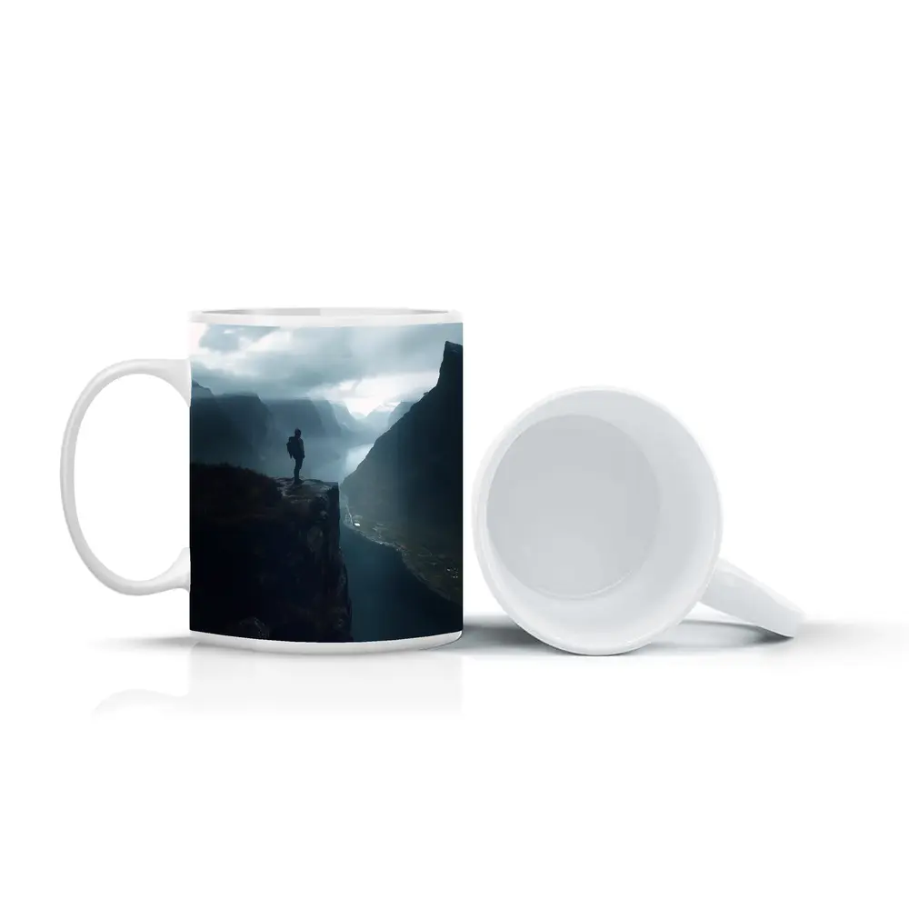 Hiker Standing On Cliff Above Misty Fjord – Mugs